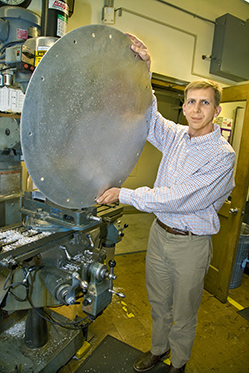 David Schlegel holds an circular metal SDSS plate